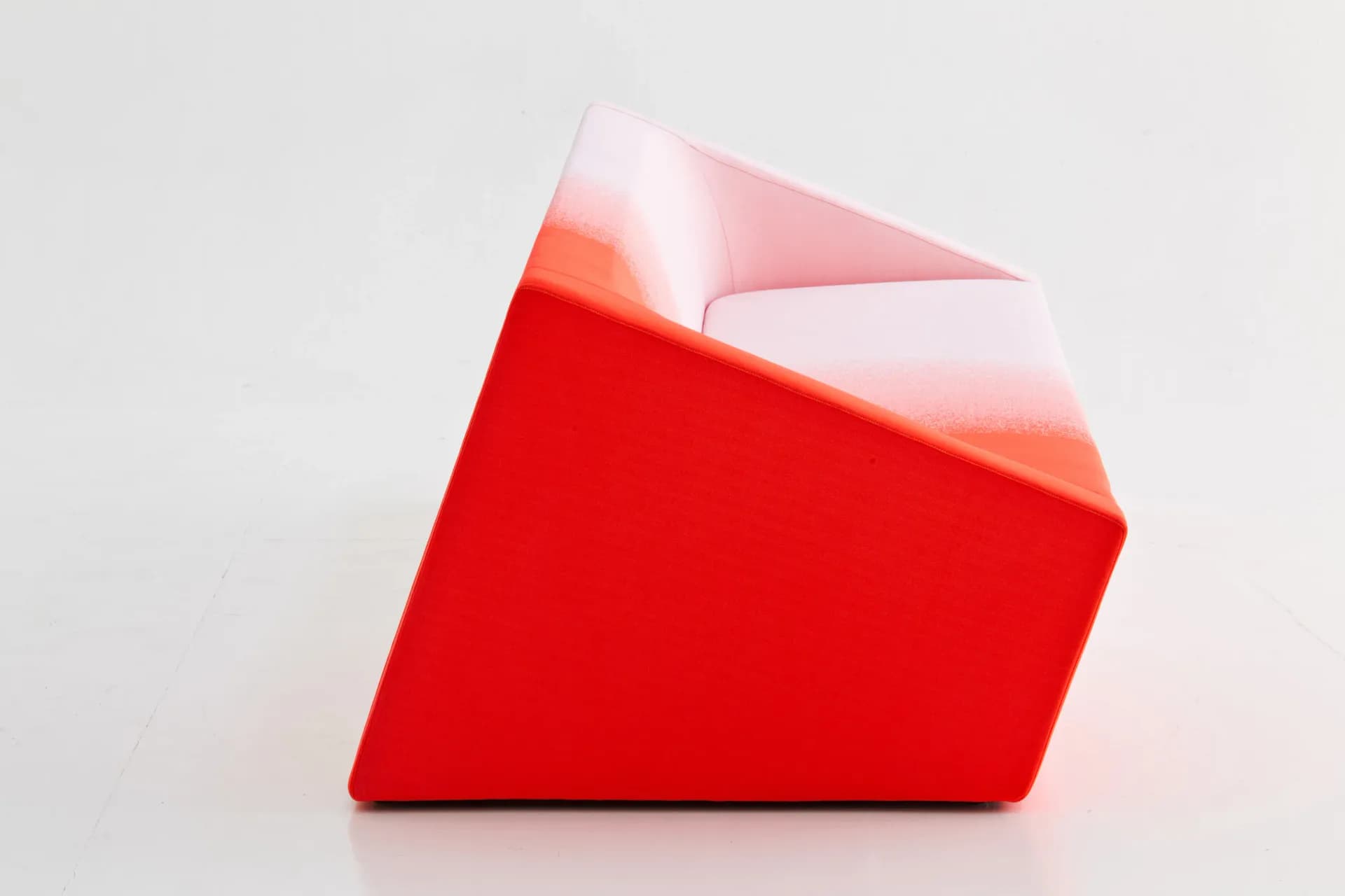 Abstract red geometric form with translucent pink planes and soft lighting, a sculptural design concept by Marc Thorpe.