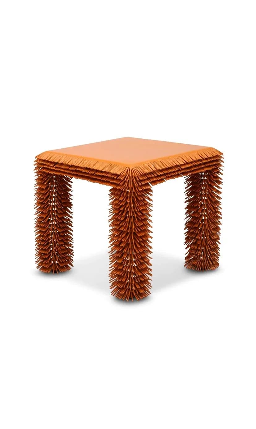 Orange sculptural stool with hedgehog-quill textured legs and flat top surface by Mark Malecki.