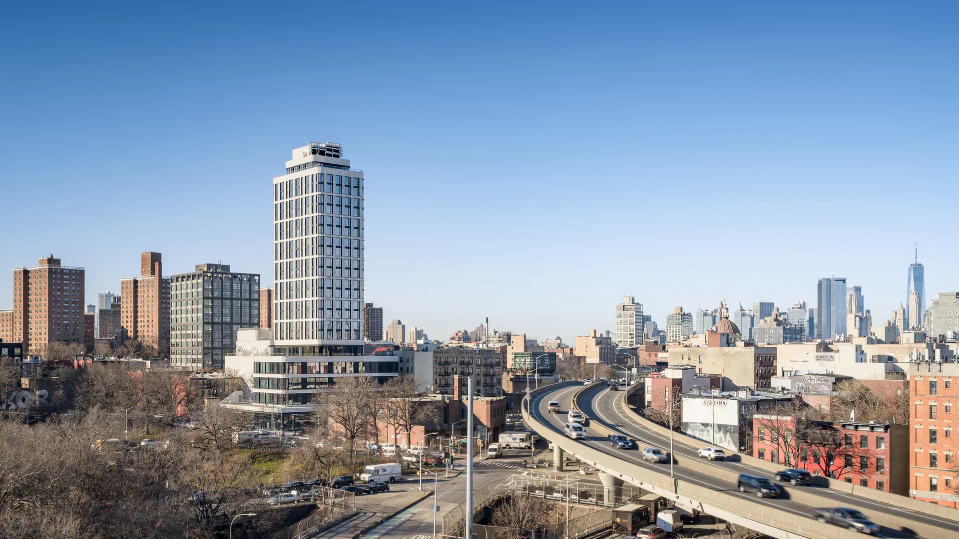 Urban landscape featuring a modernist tower and elevated highway interchange with Manhattan skyline in background, designed by Matilde Pietrabissa.