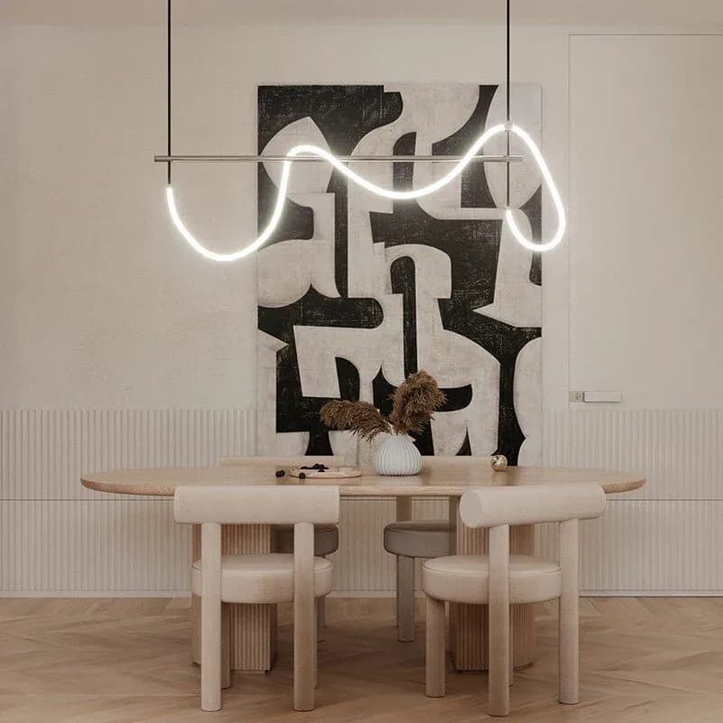 Minimalist dining space with sculptural wooden table and chairs, dramatic black abstract wall art, and suspended neon light installation by May WU.