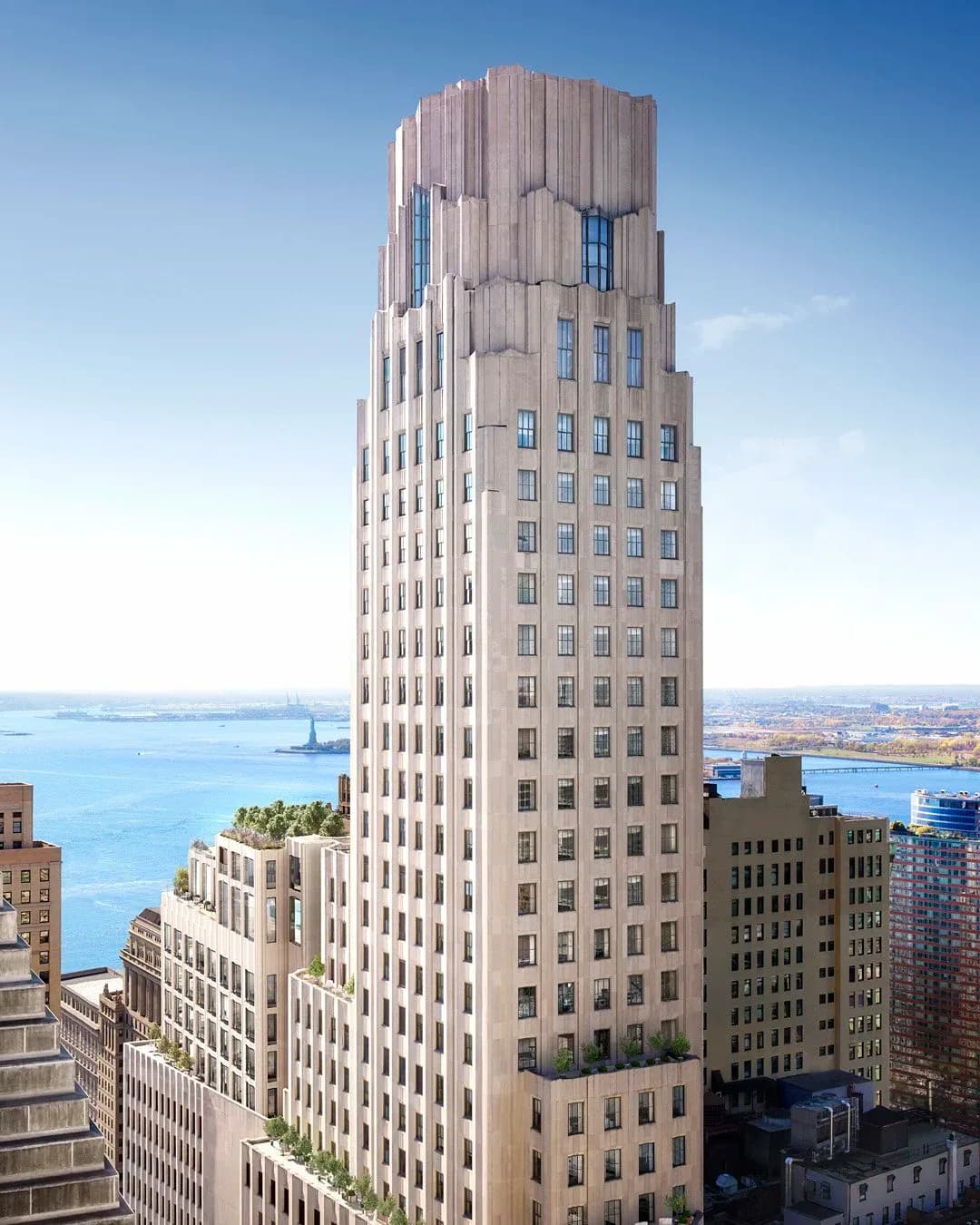 Tall Art Deco residential tower with cream-colored brick facade, stepped crown, and regular window grid overlooking waterfront, designed by Michael F. Doyle.