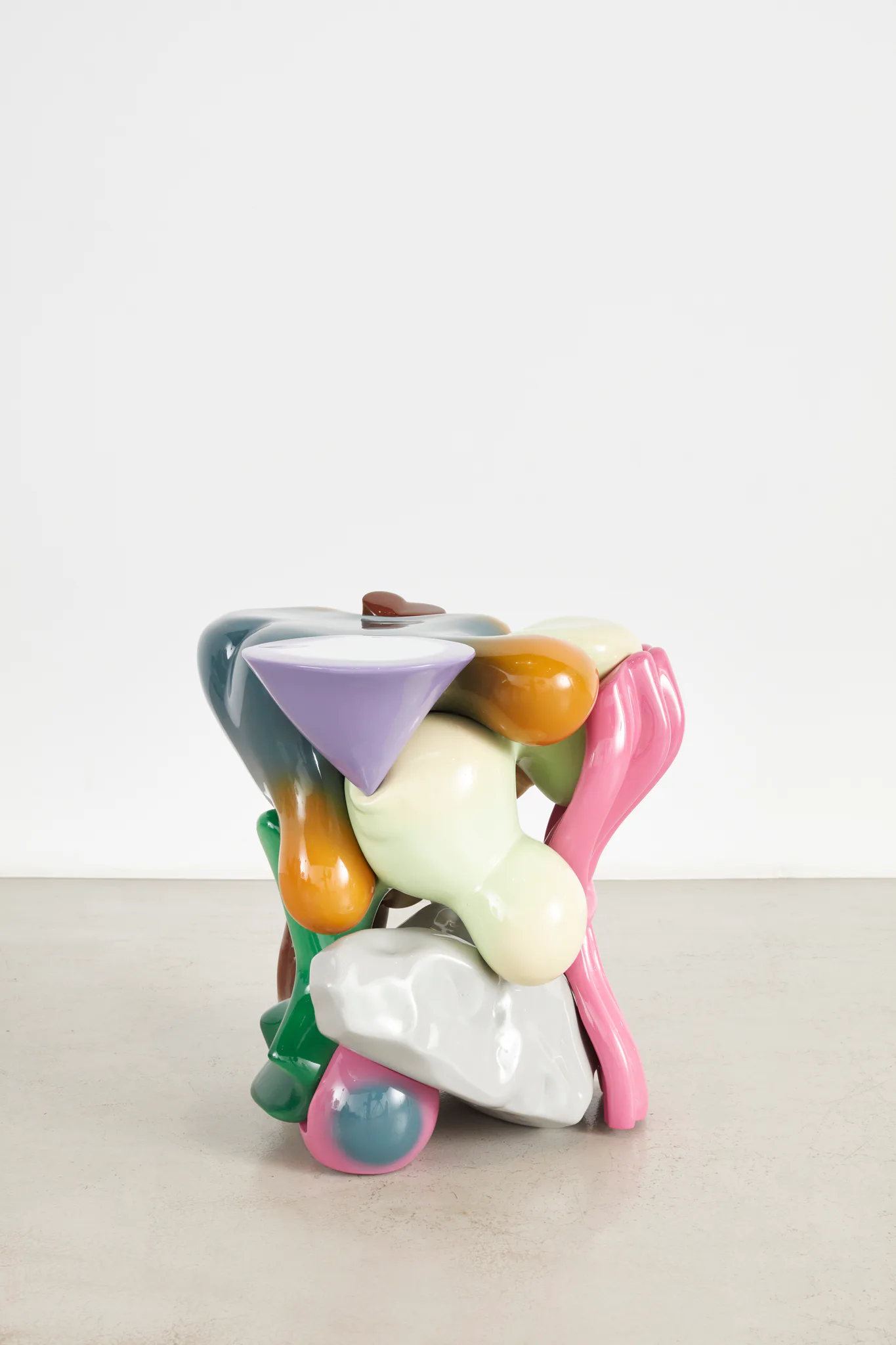 Colorful abstract sculptural object combining organic and geometric forms in pink, purple, yellow, green, and white, by Misha Kahn.