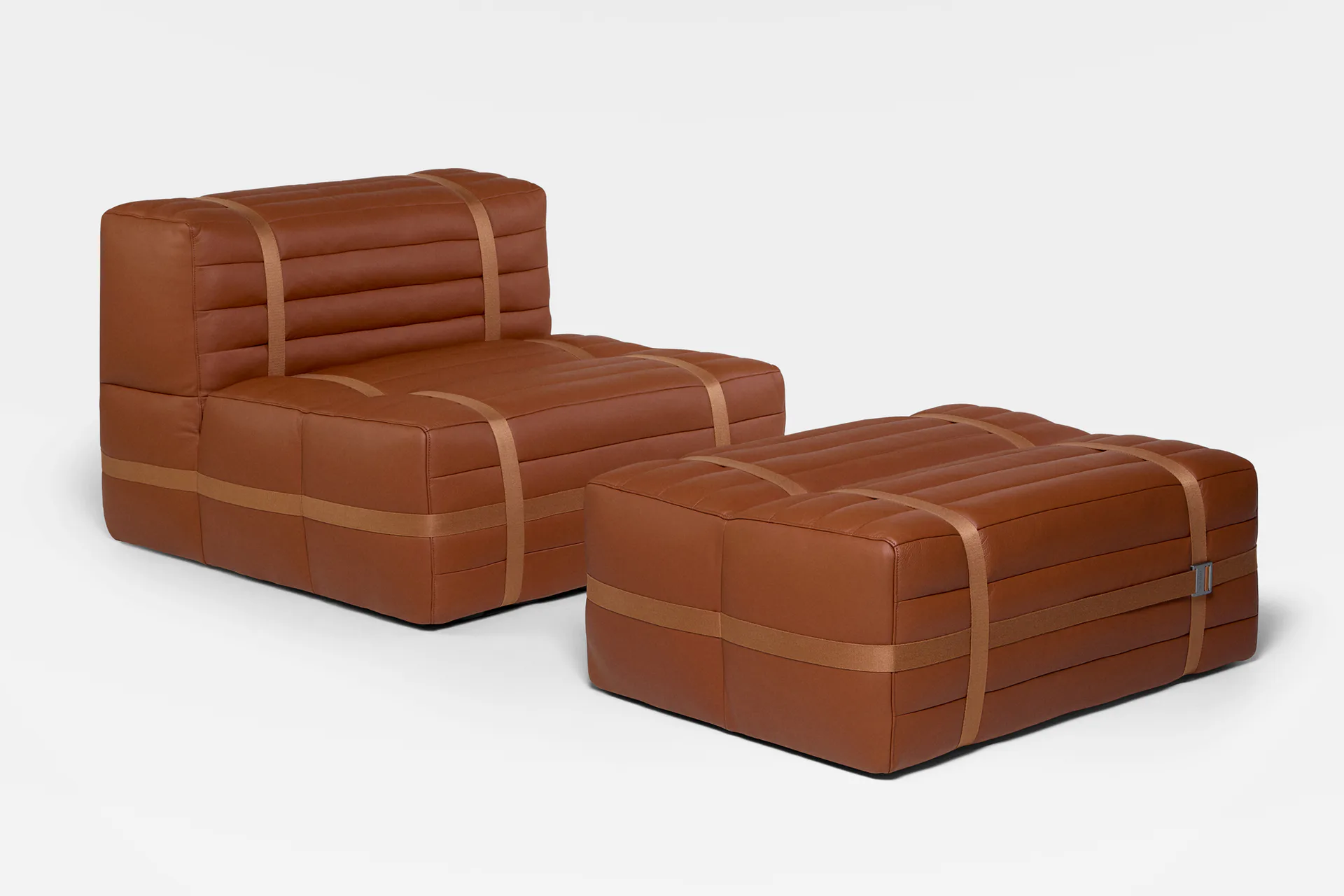 Two brown leather modular furniture pieces with quilted detailing and straps, rendered with soft lighting and minimal shadows by Nicholas Baker.