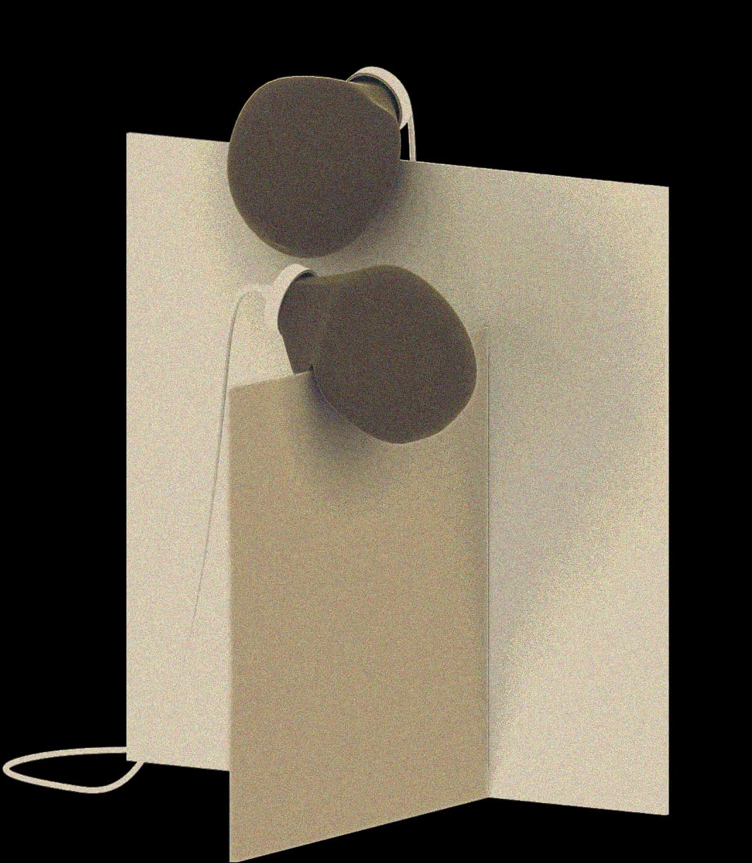 Minimalist sculptural object with cream-colored folded paper form and two dark spherical elements suspended by metal wire, a product design by Nicholas Bijan Pourfard.
