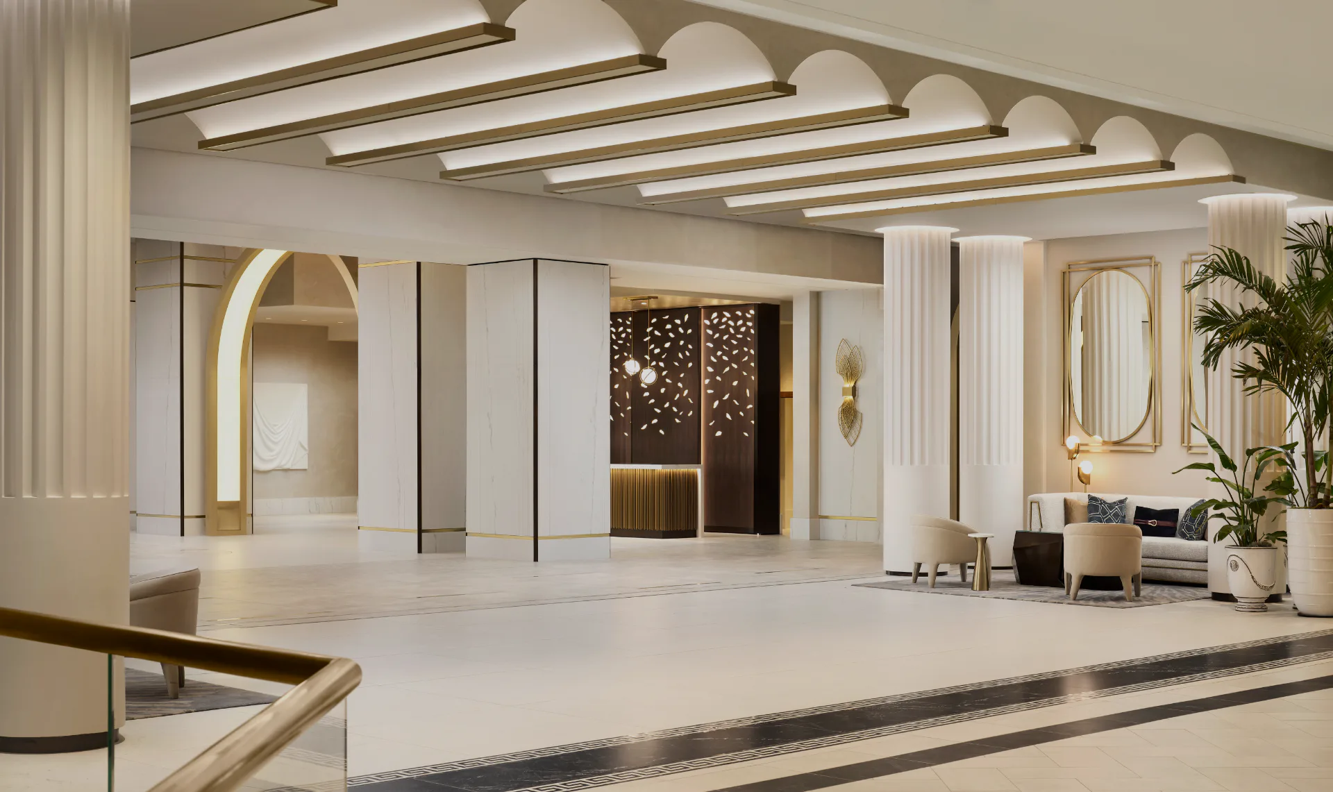Modern luxury lobby with linear ceiling lights, marble flooring, brass-accented alcoves, and botanical elements designed by Olivia Cooper.