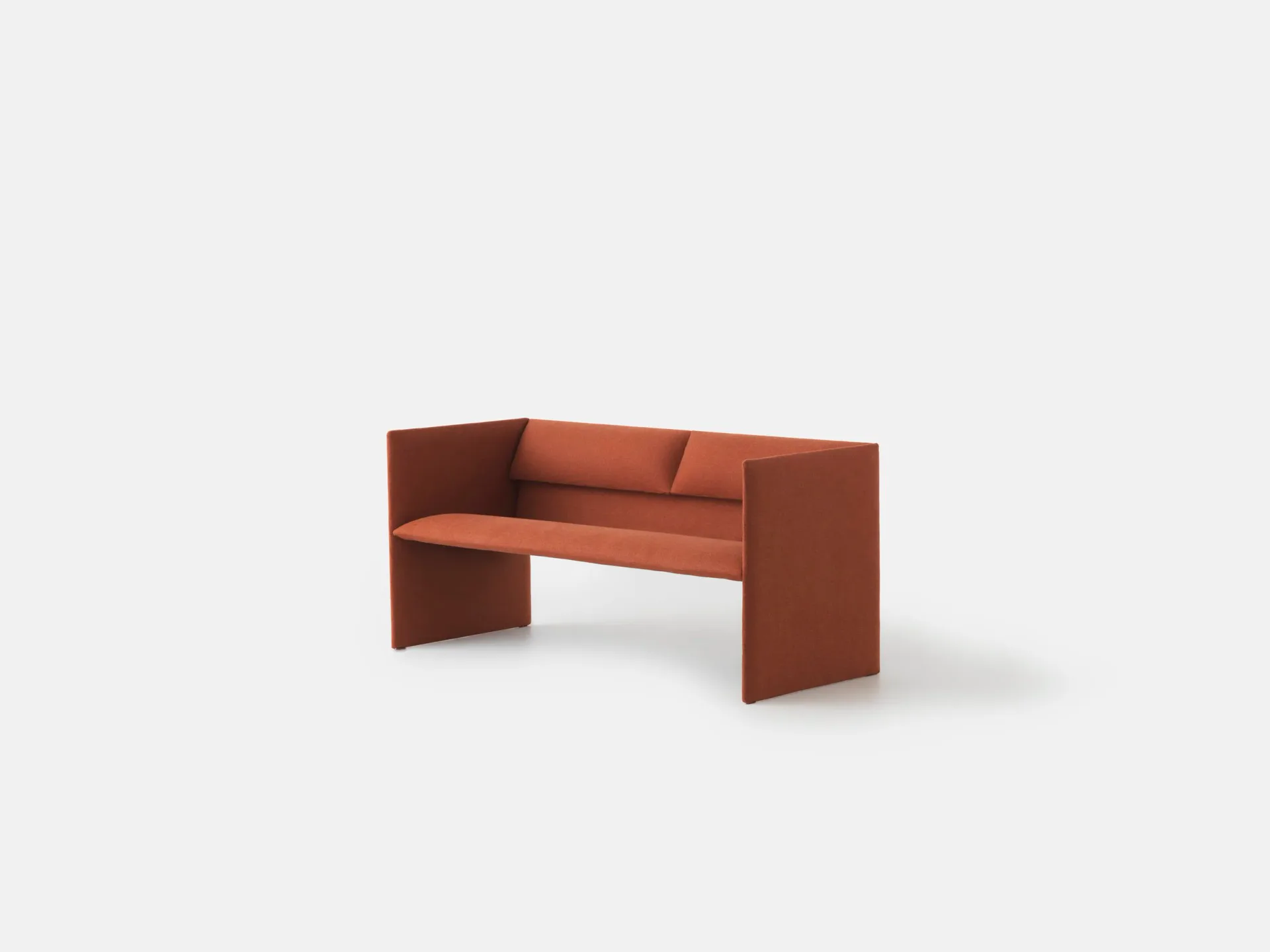 Terracotta-colored modular bench with angular geometric forms and cushioned seating, rendered against a neutral background by Philippe Malouin.