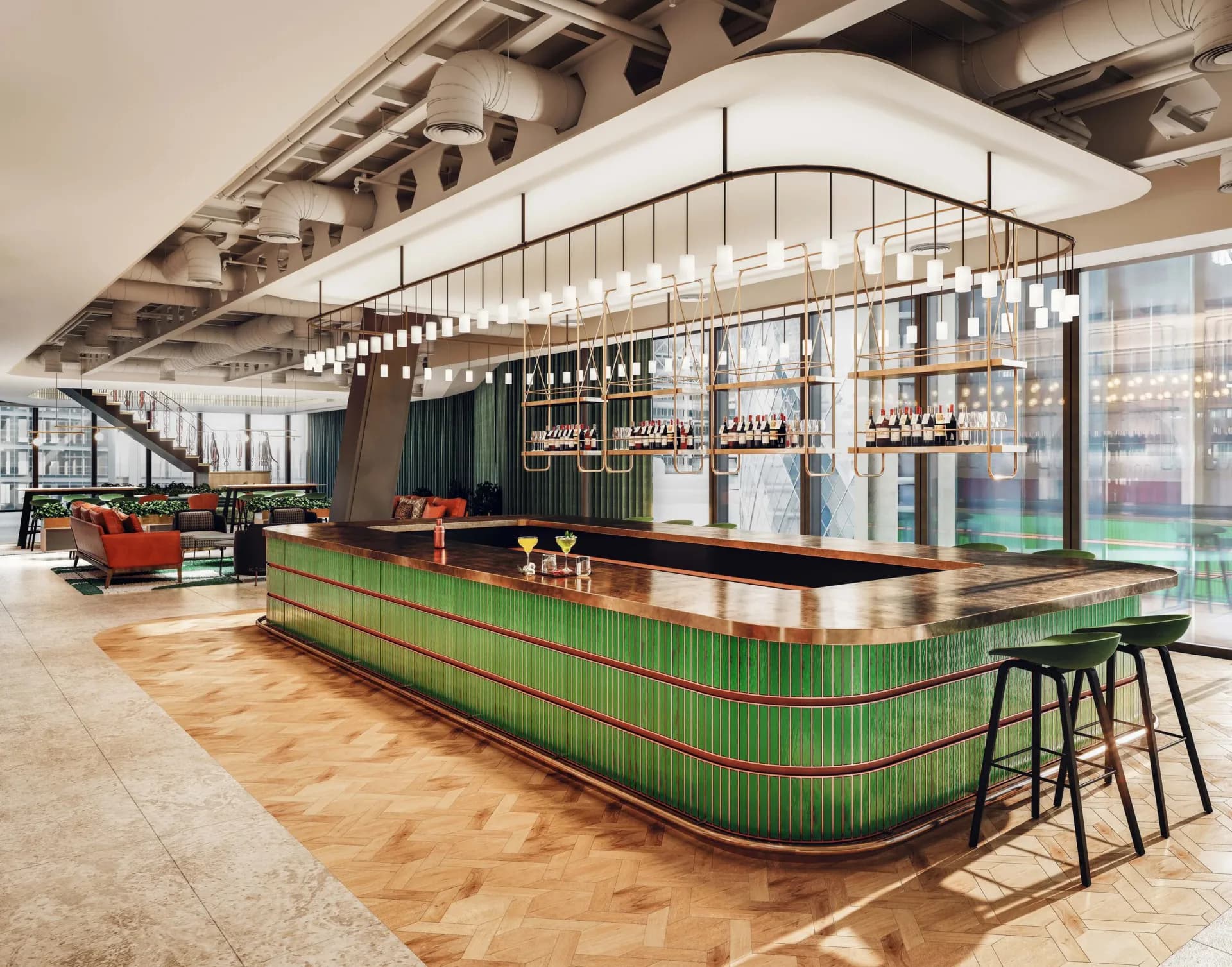 Modern bar interior with curved green ribbed counter, suspended linear chandelier, and floor-to-ceiling windows overlooking green landscape, designed by Prutha Raithatha.