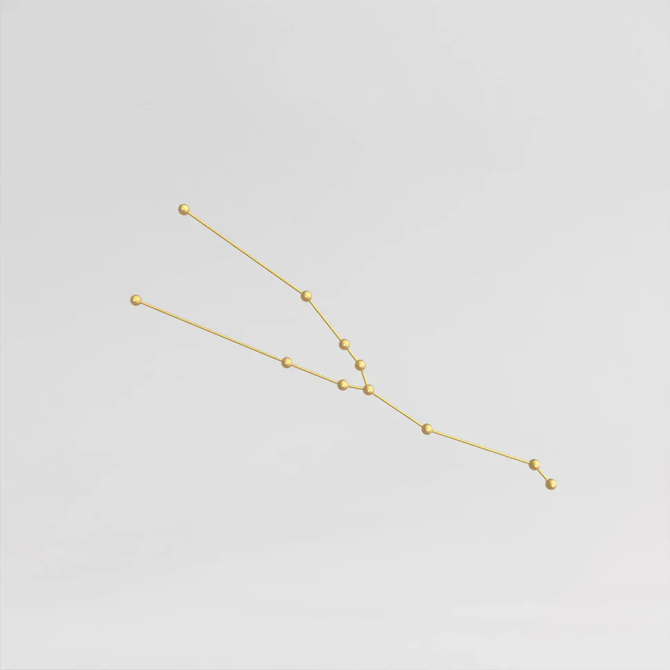 Gold-beaded string lights arranged in descending curved lines against a neutral background, a delicate lighting installation by Richard Clarkson.