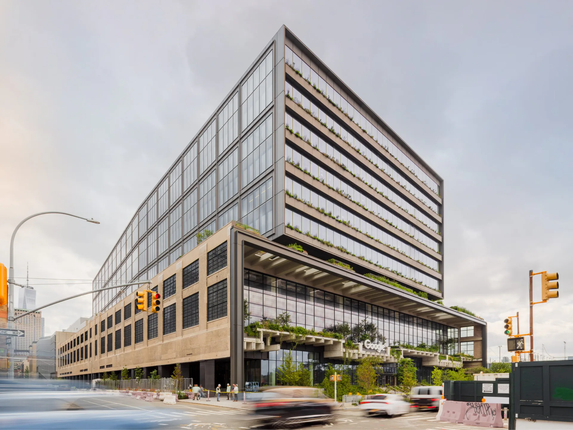 Contemporary mixed-use building with stacked horizontal volumes, ground-floor glazing, and upper-level striping, designed by Rick Cook.