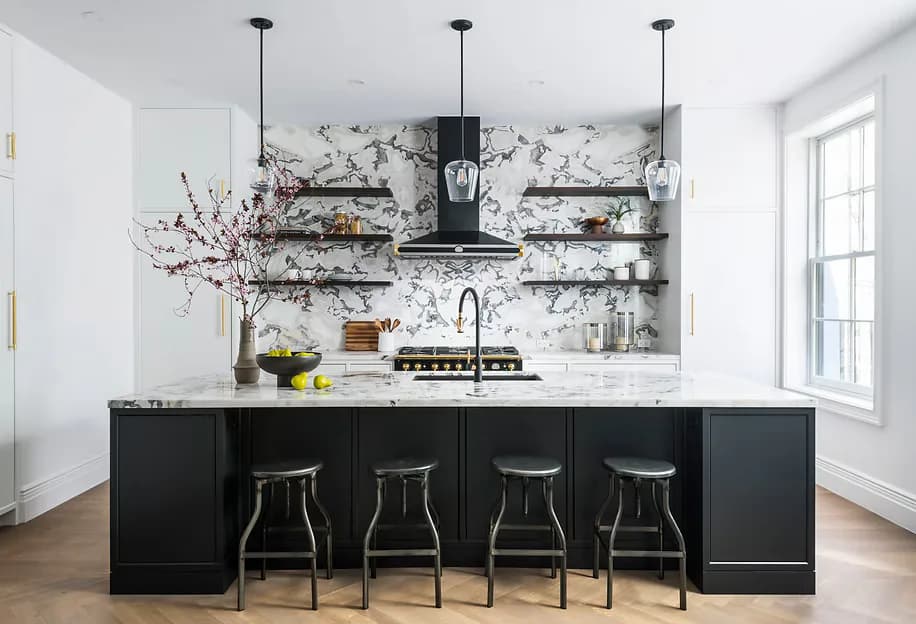 Modern kitchen with black cabinetry, marble backsplash, floating shelves, and bar seating by Shai Arviv.