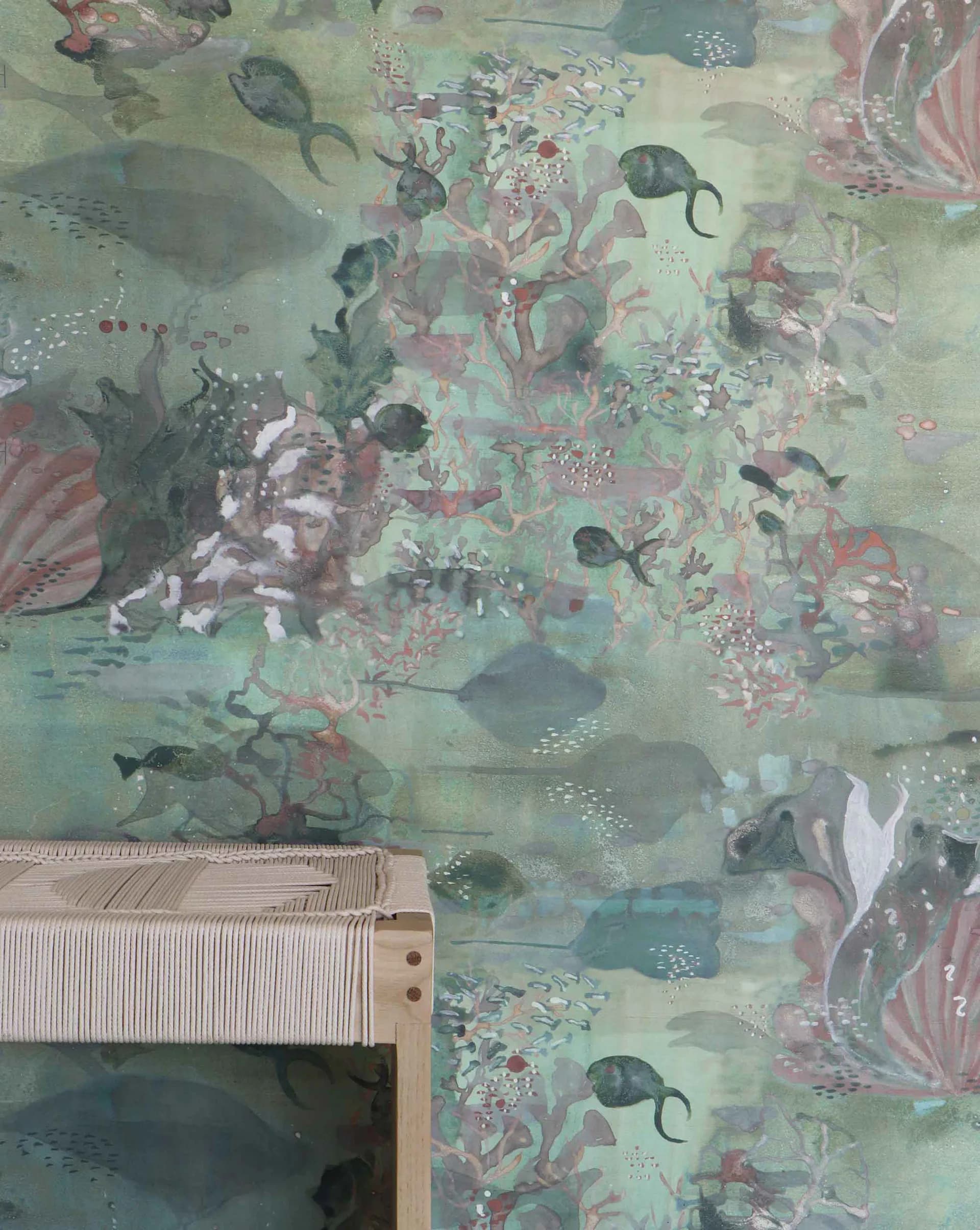 Detailed wallpaper design featuring underwater coral reef motifs with fish, sea creatures, and botanical elements in soft greens, pinks, and teals by Shanan Campanaro.