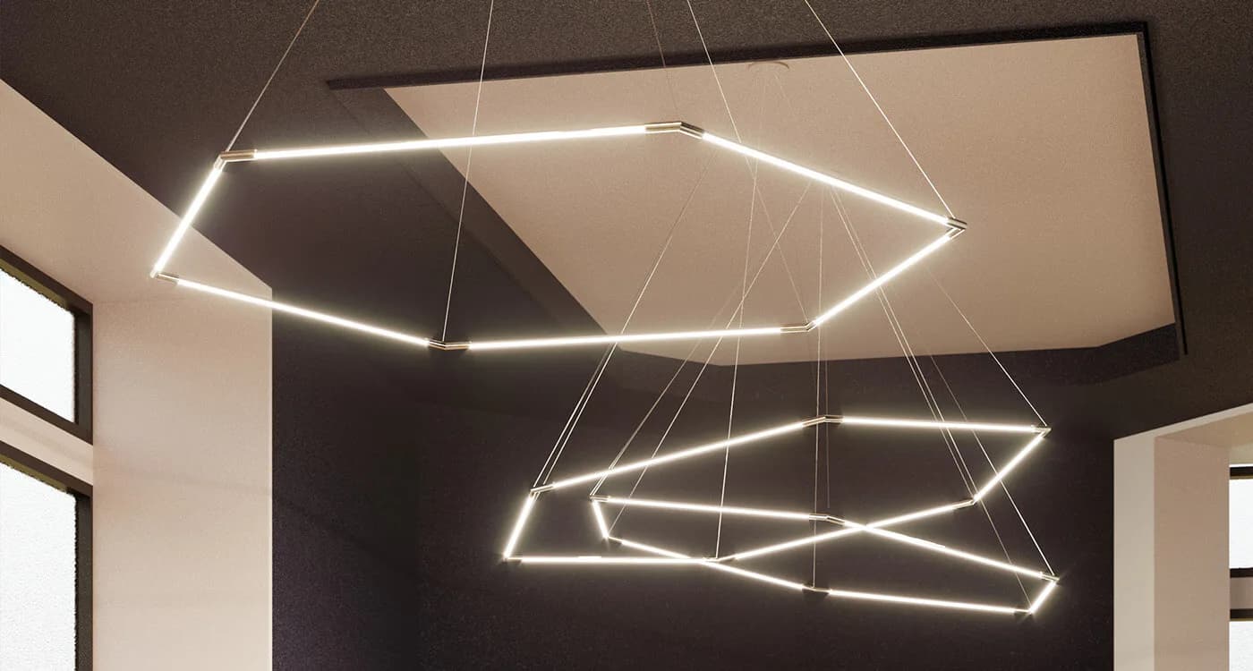 Modern ceiling installation featuring two geometric pendant light fixtures with linear LED elements suspended in a contemporary interior space by Shant Madjarian.