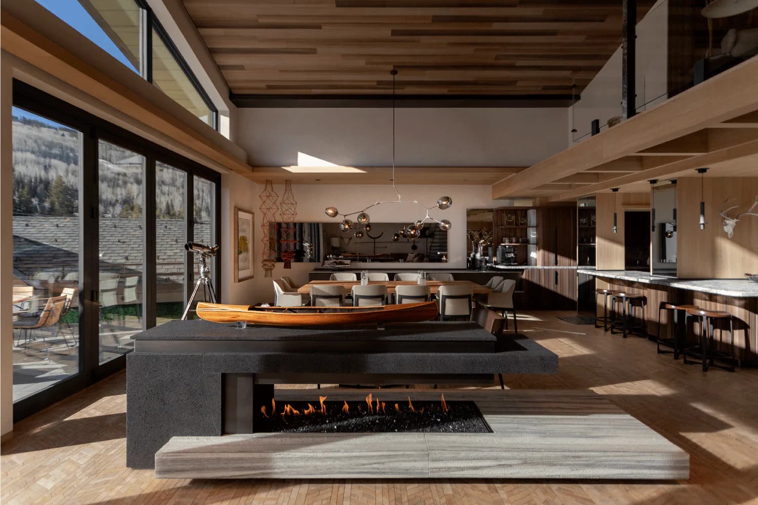 Modern luxury interior with floating fireplace, wooden ceiling, and floor-to-ceiling windows overlooking mountains, designed by Simon Hamui.