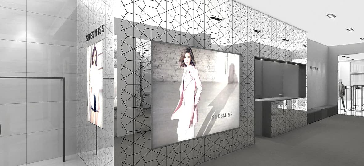 Modern retail interior with geometric patterned wall cladding, illuminated display screens, and polished flooring by Soojin Kim.