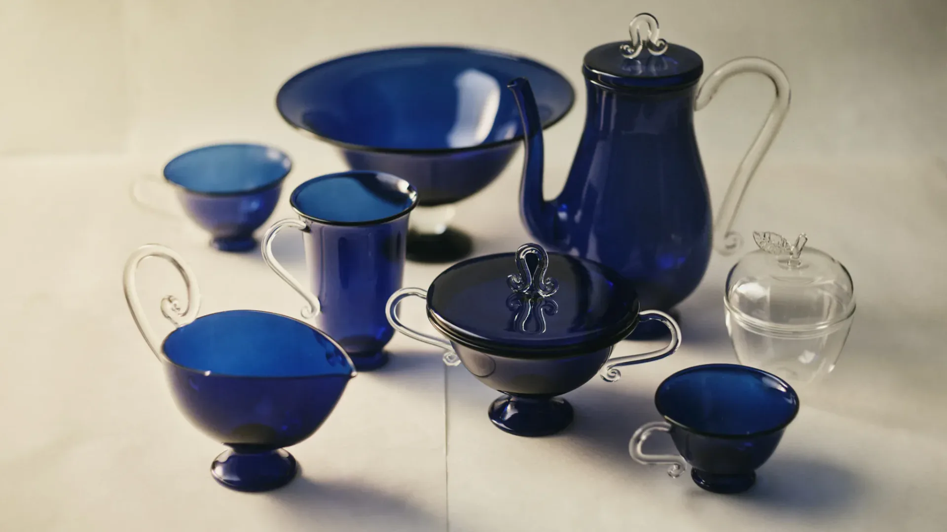 Blue ceramic tableware collection featuring bowls, vessels, and serving pieces with elegant handles and glossy glazes by Sophie Lou Jacobsen.