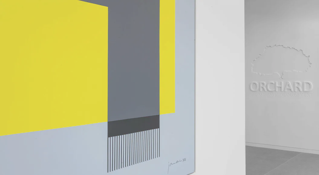 Abstract interior space with bold yellow and gray geometric wall panels, vertical striations, and soft blue-gray flooring, branded 'ORCHARD' by Stephanie Gibson-Roberts.