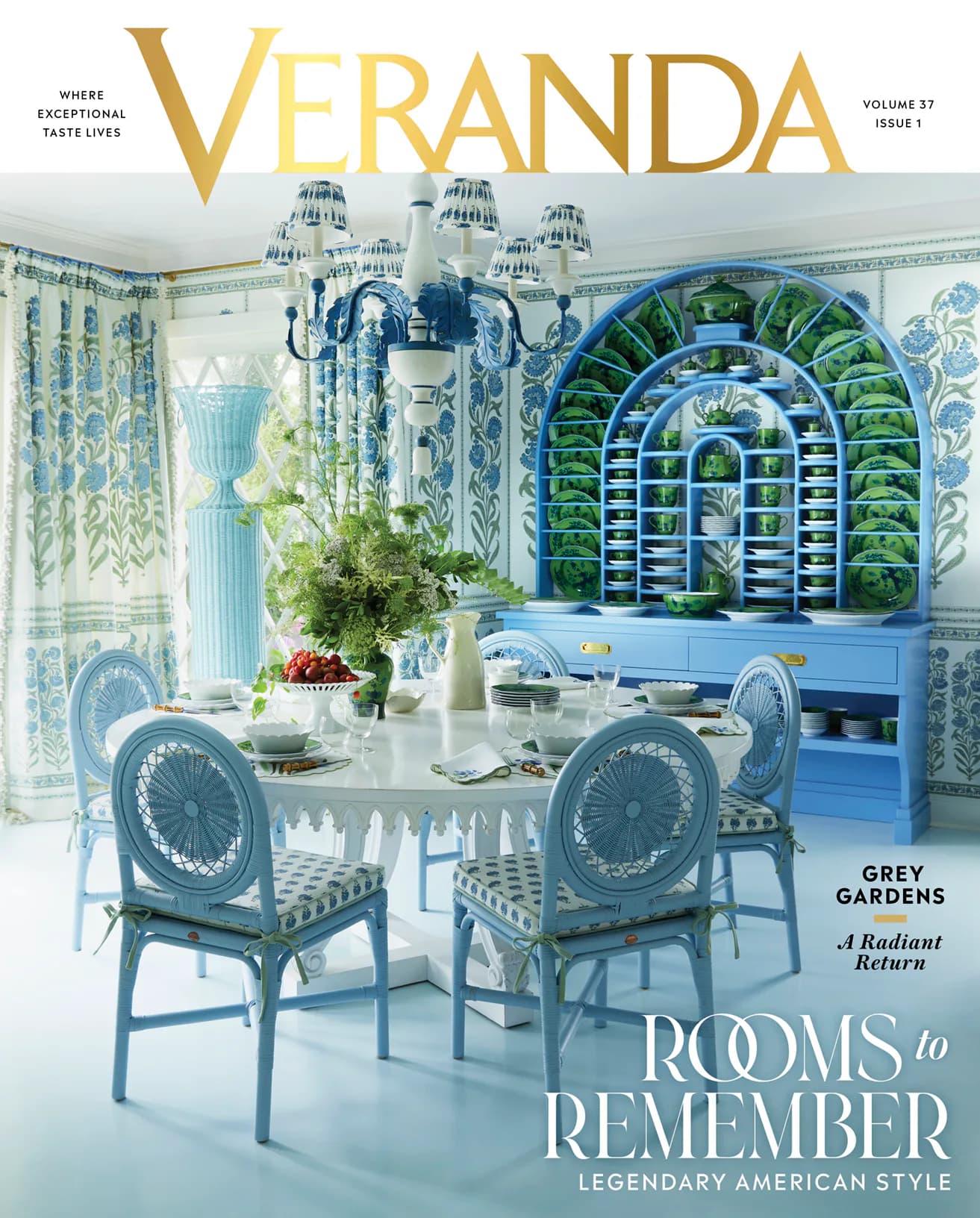 Dining room with blue and white palette, featuring patterned chairs, glass table, arched green botanical niche, and layered drapery by Steven Gambrel.