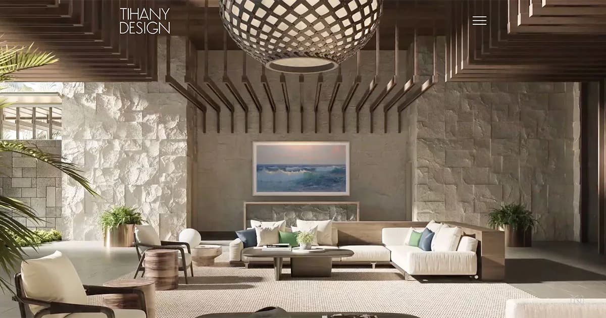 Luxurious modern lounge with taupe tones, geometric ceiling fixture, cream sectional sofa, and serene seascape artwork, designed by Su Ergeneli.