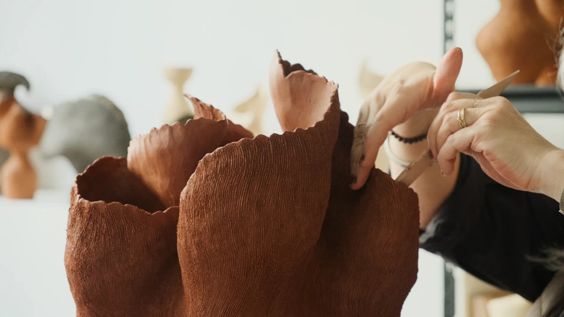 Crumpled terracotta paper sculpture with organic, petal-like forms and natural texture details by Tania Whalen.