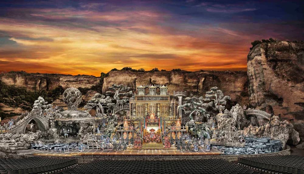 Ornate palatial structure with golden detailing nestled among dramatic rocky cliffs at sunset by Thomas Espinos.