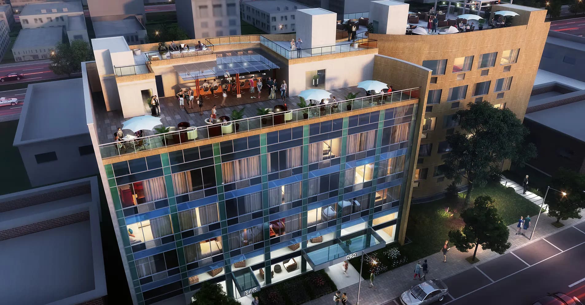 Modern multi-story residential building with warm wood and blue-toned facades, illuminated interiors, rooftop terrace, and landscaping by Thomas Gilman.