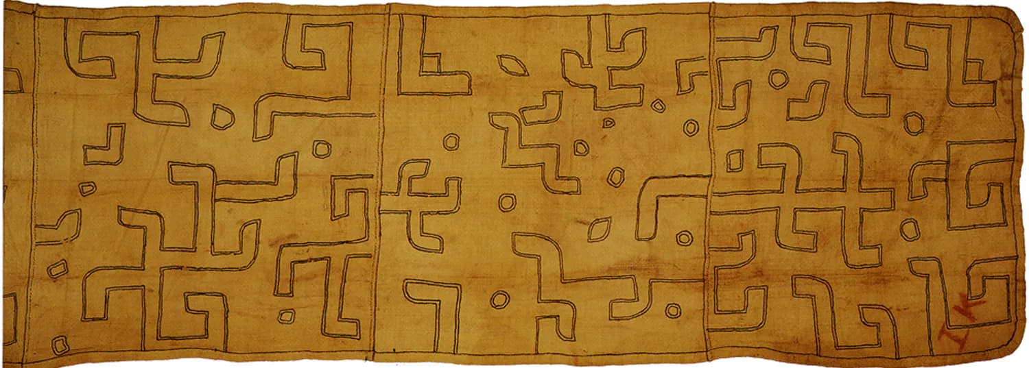 Ochre-toned textile or carpet featuring geometric maze-like pattern in warm earth tones, likely a design work by Tod Williams.