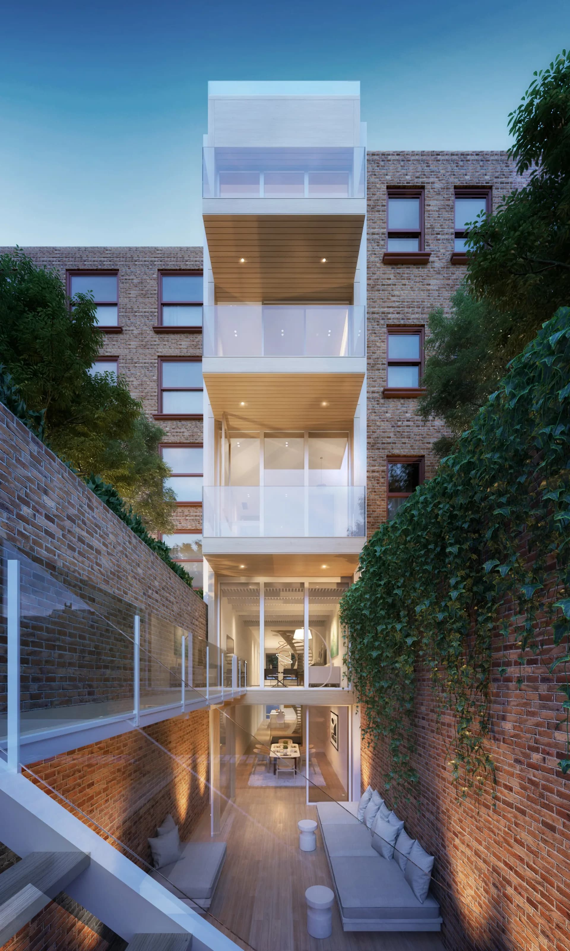 Tall narrow townhouse with stacked white and wood-clad balconies between brick walls, illuminated interior spaces visible at night by Tomas Dordevic.
