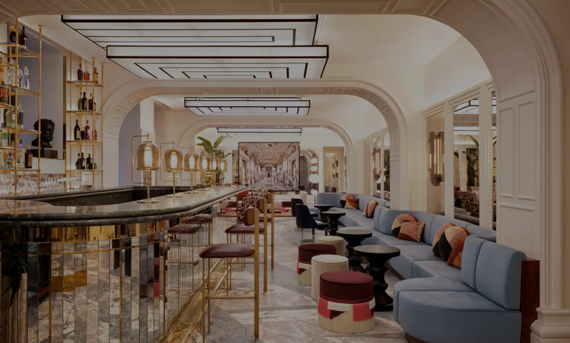 Luxurious lounge interior with curved archways, marble flooring, brass-accented bar, and upholstered seating in warm tones by Will Meyer.