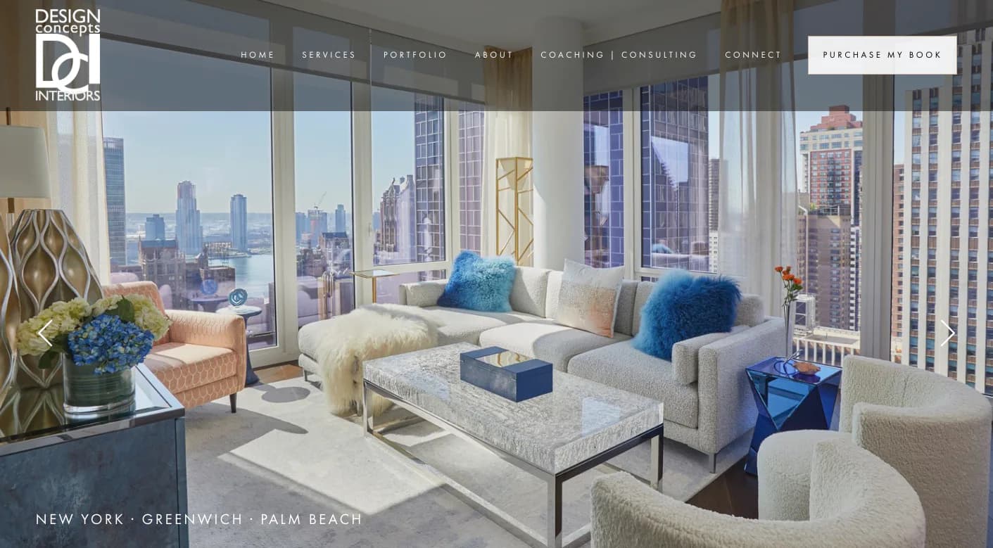 Luxurious high-rise living room with floor-to-ceiling windows overlooking Manhattan skyline, featuring cream and blue upholstered seating, geometric patterned accents, and modern furnishings by Yasemin Turckan.