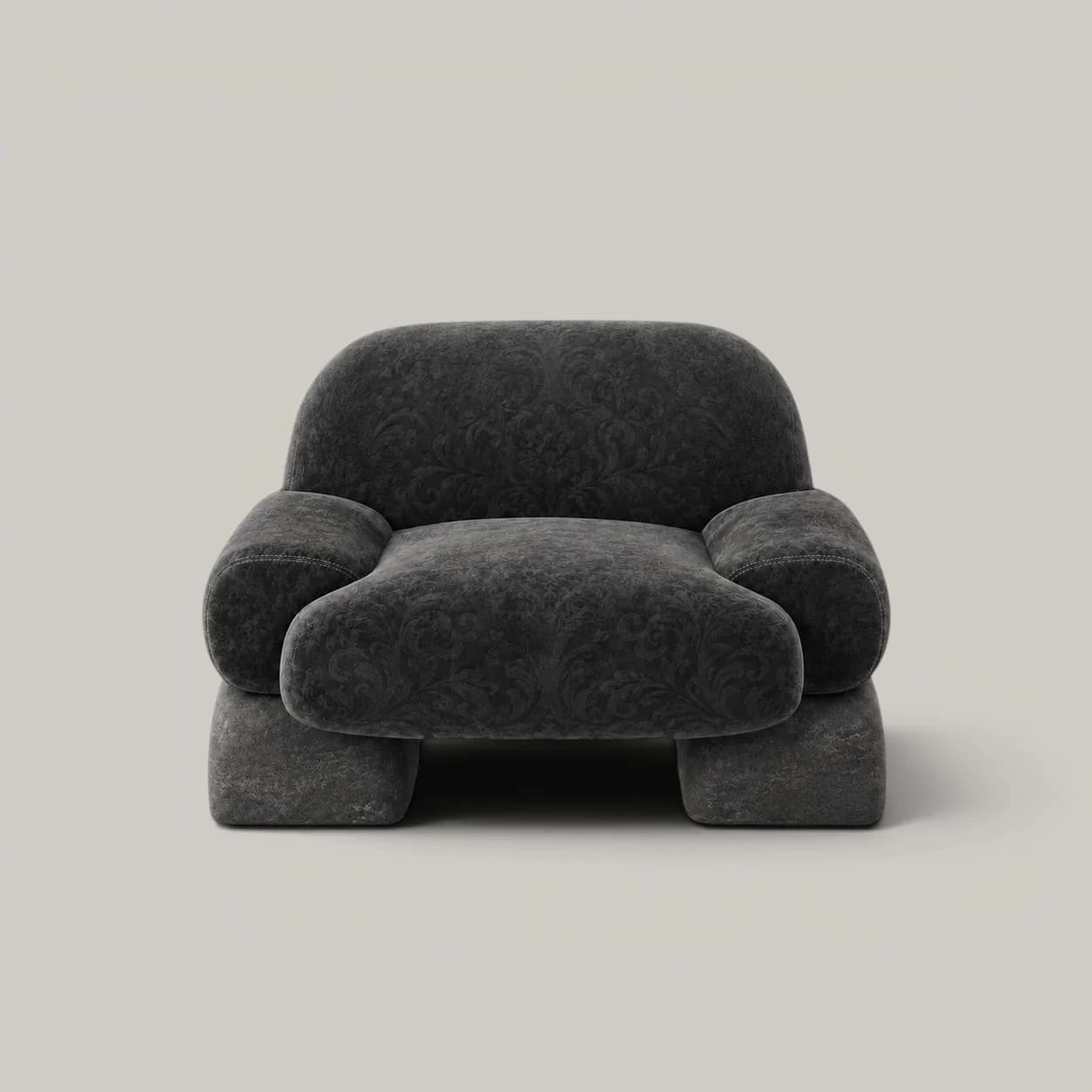 Sculptural gray upholstered armchair with rounded forms and chunky proportions against a neutral background by Alter Ego Studio.