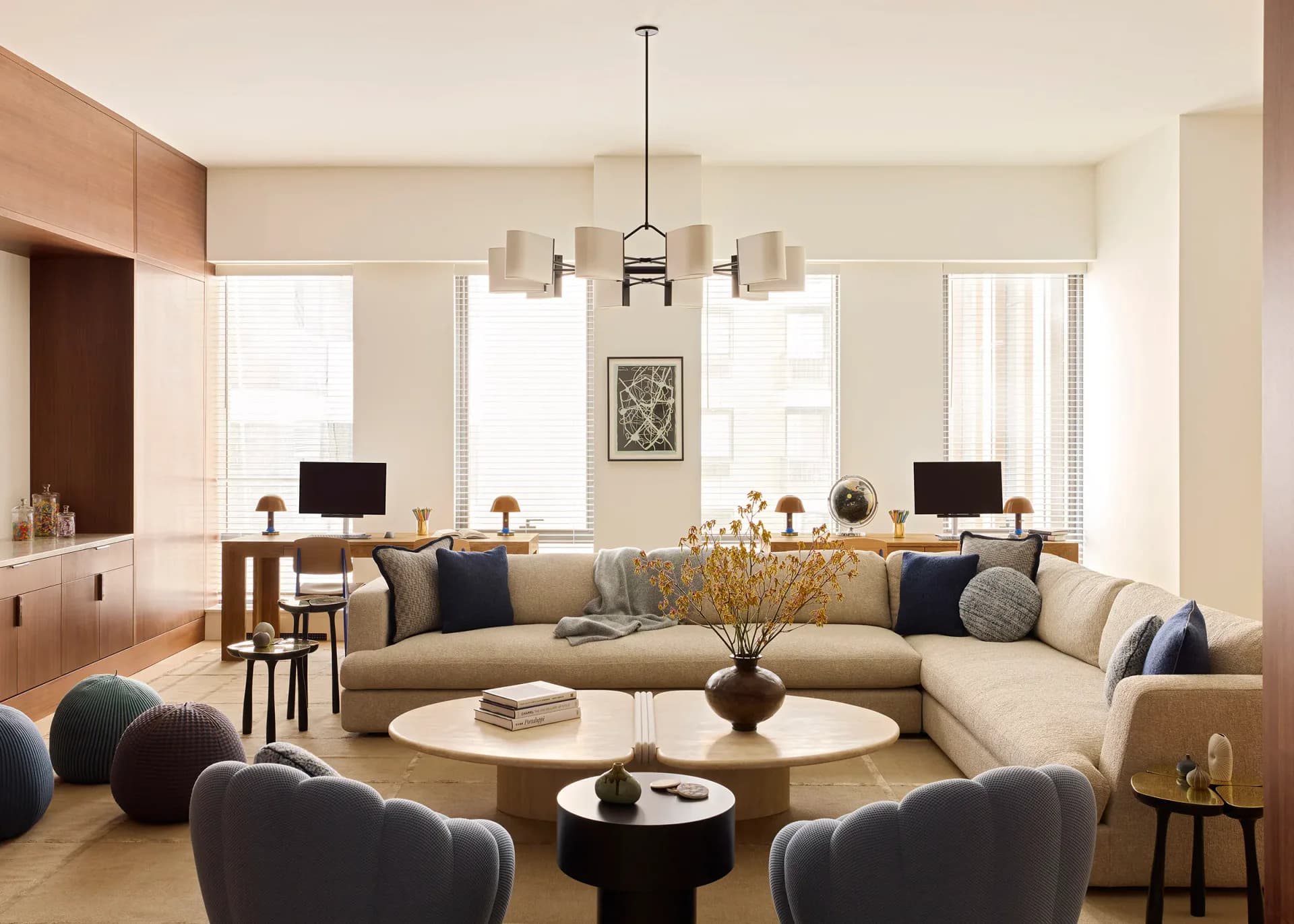 Modern living room with curved sectional sofa, round coffee table, contemporary pendant lighting, and natural wood accents by Andrew B. Ballard, AIA Architecture & Interior Design.