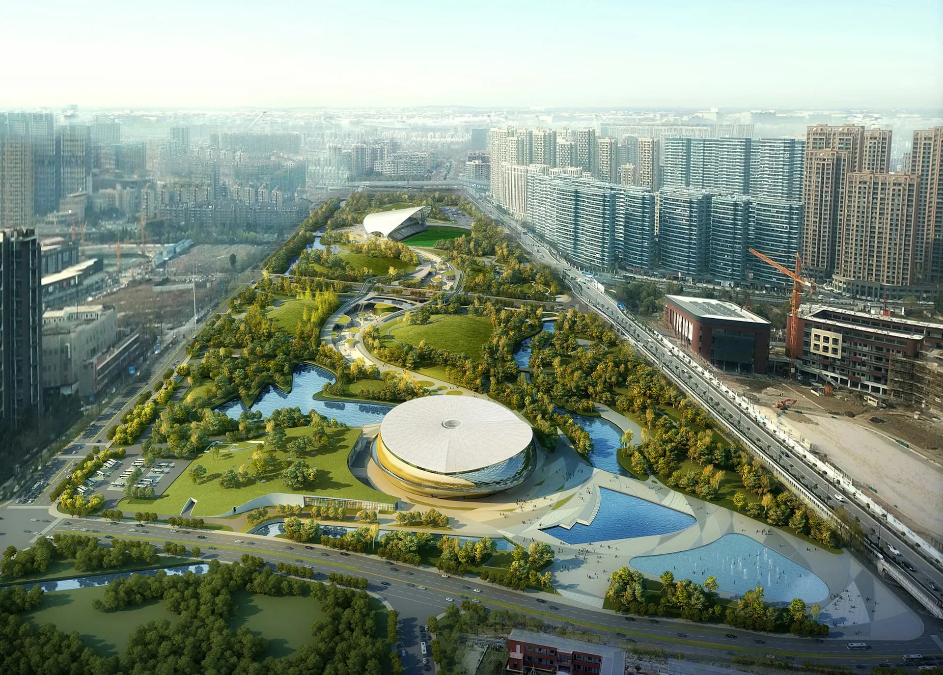 Aerial view of a contemporary urban park with a distinctive circular white building, flowing water features, and verdant landscaping integrated into a dense cityscape by Archi-Tectonics NYC, LLC.