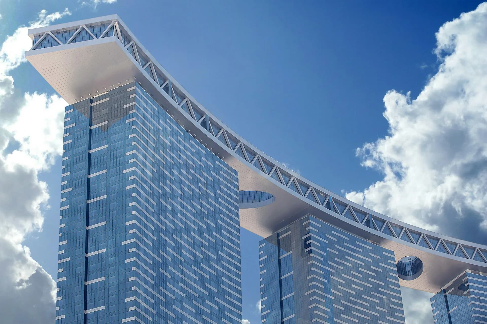 Modern curved high-rise tower with blue glass facade and distinctive sculptural white architectural elements against a bright blue sky, by Arquitectonica.
