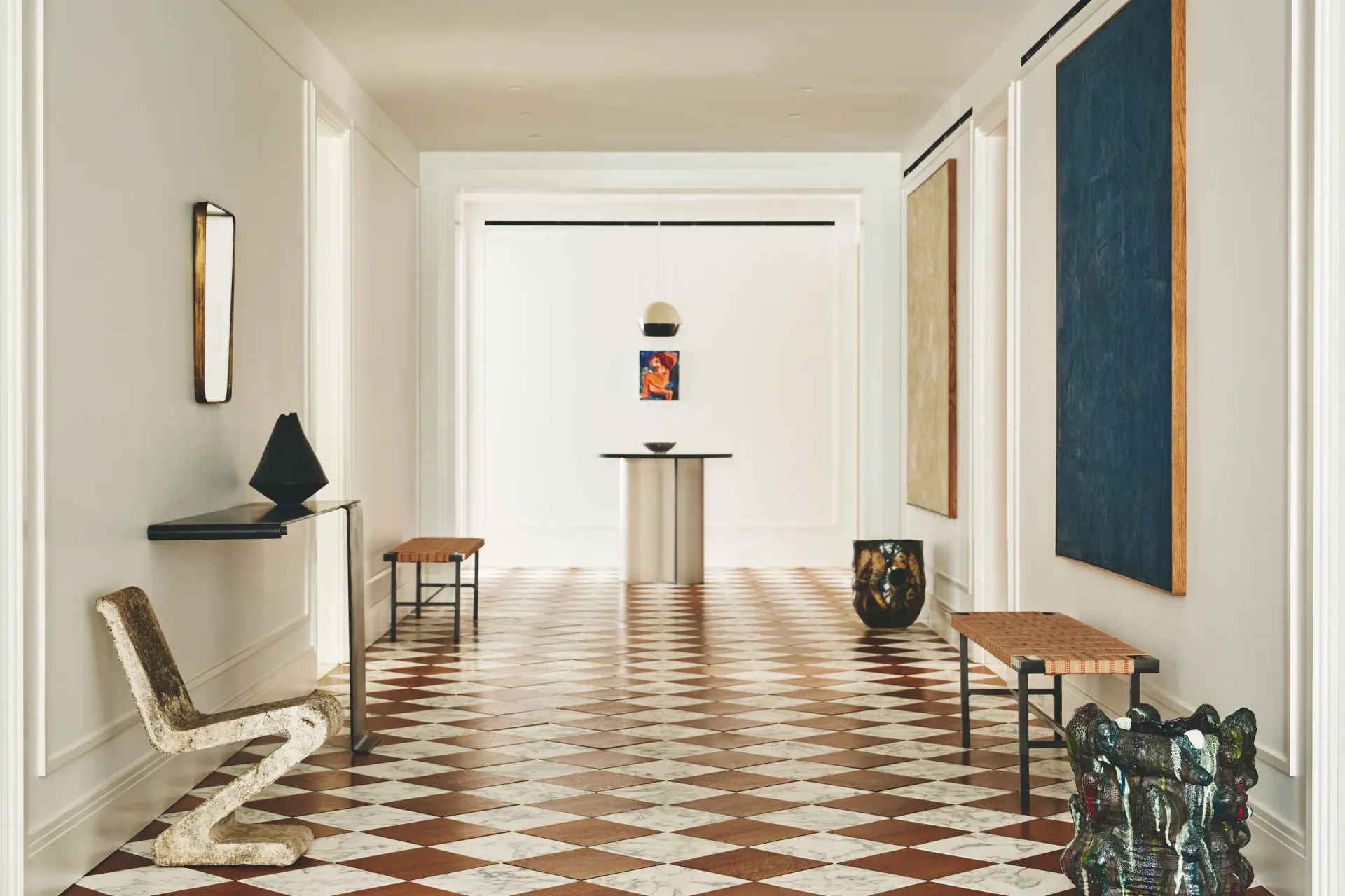 A minimalist gallery hallway with geometric terracotta and cream floor tiles, white walls, sculptural furniture pieces, and artworks on pedestals, rendered by Ashe Leandro.