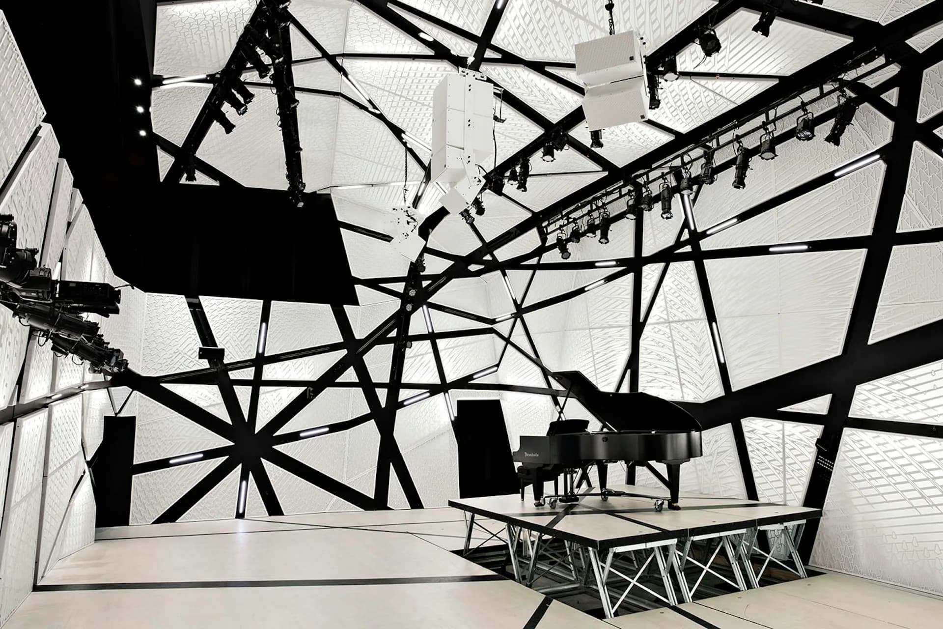 Dramatic black steel structural installation with grand piano silhouette in minimalist white gallery space by Bureau V.