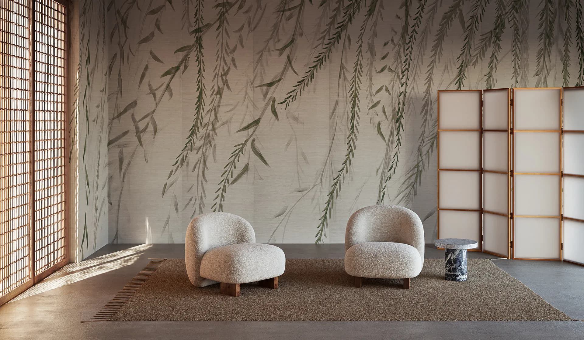 Modern interior with two cream-colored curved chairs on a taupe area rug, featuring a wallpapered accent wall with willow branch botanical motifs and a wooden-framed window partition by Calico Wallpaper.