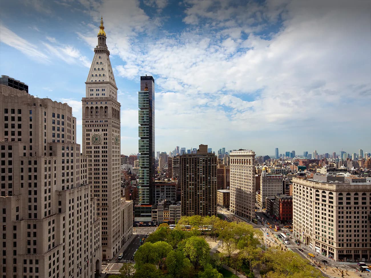 Aerial view of Madison Square Park in Manhattan with surrounding historic and modern architecture, vibrant green canopy, and city skyline by CetraRuddy.