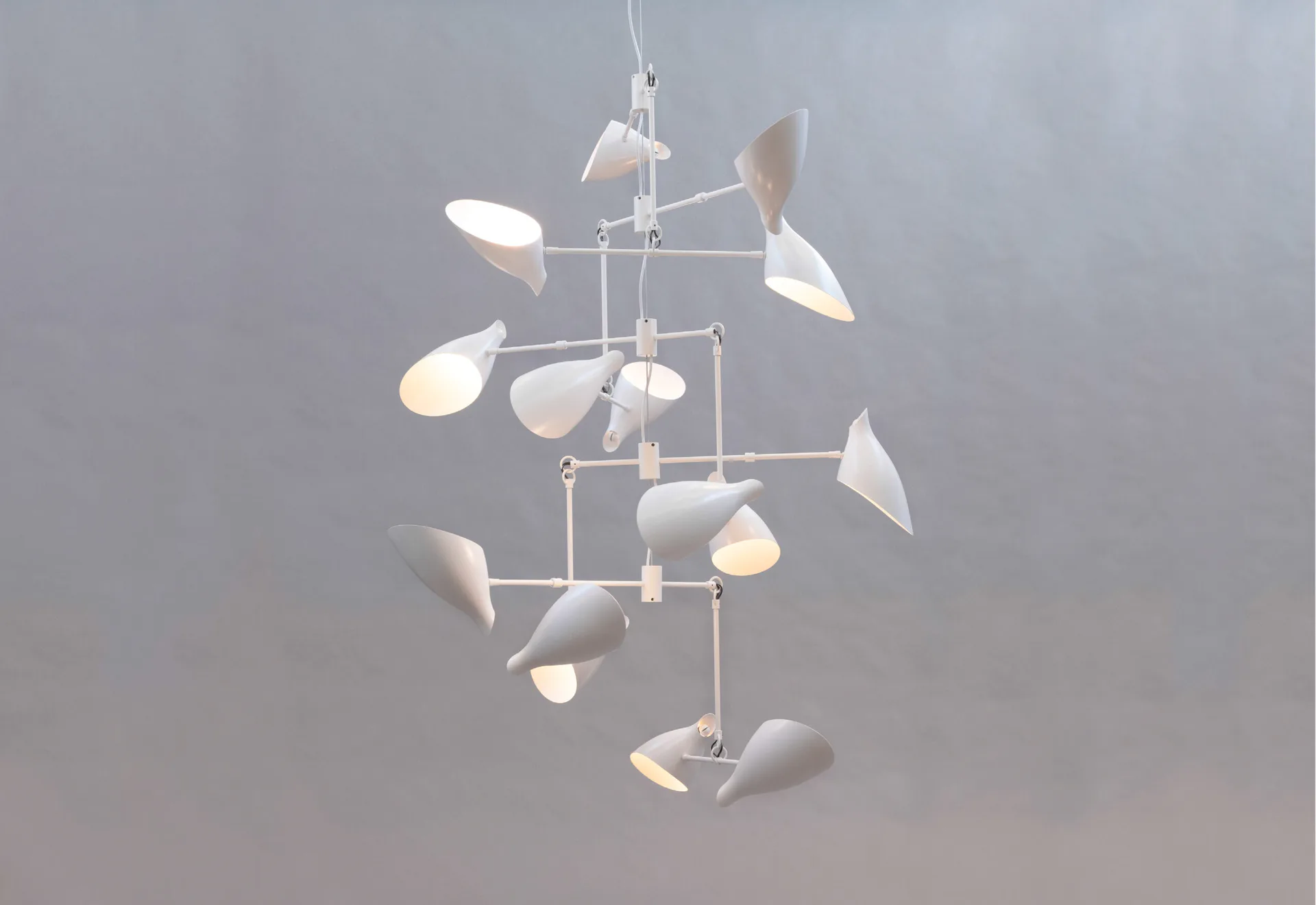 White sculptural mobile chandelier with organic petal-like forms suspended at varying heights against neutral background by David Weeks Studio.
