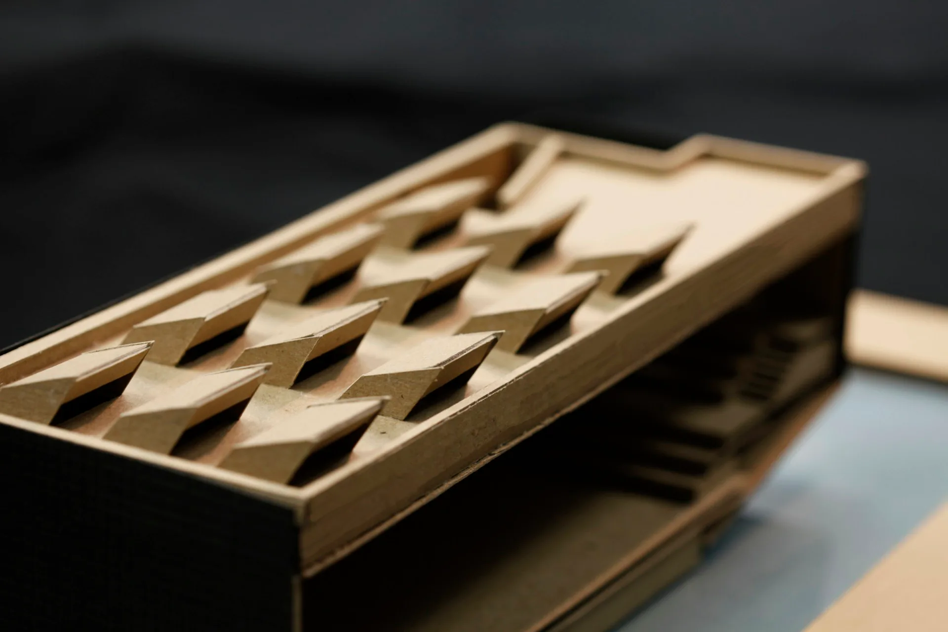 Brass architectural detail with geometric diamond cutout pattern, showcasing precision metalwork and modern design by David Yum Architects.