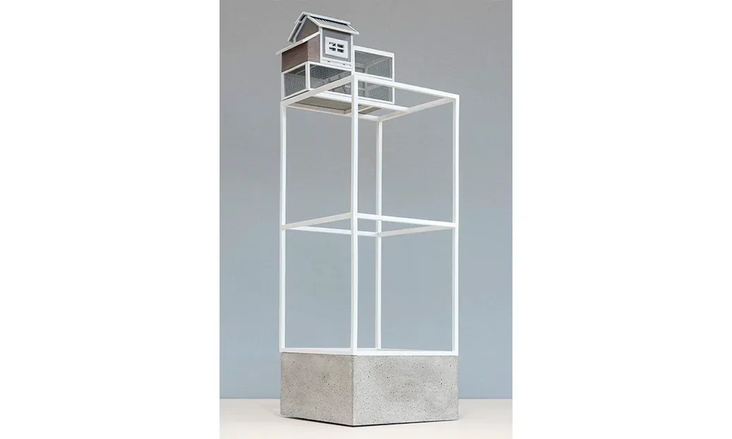 Tall glass display case with white steel frame, concrete base, and interior shelving, designed by DCM Fabrication Inc.
