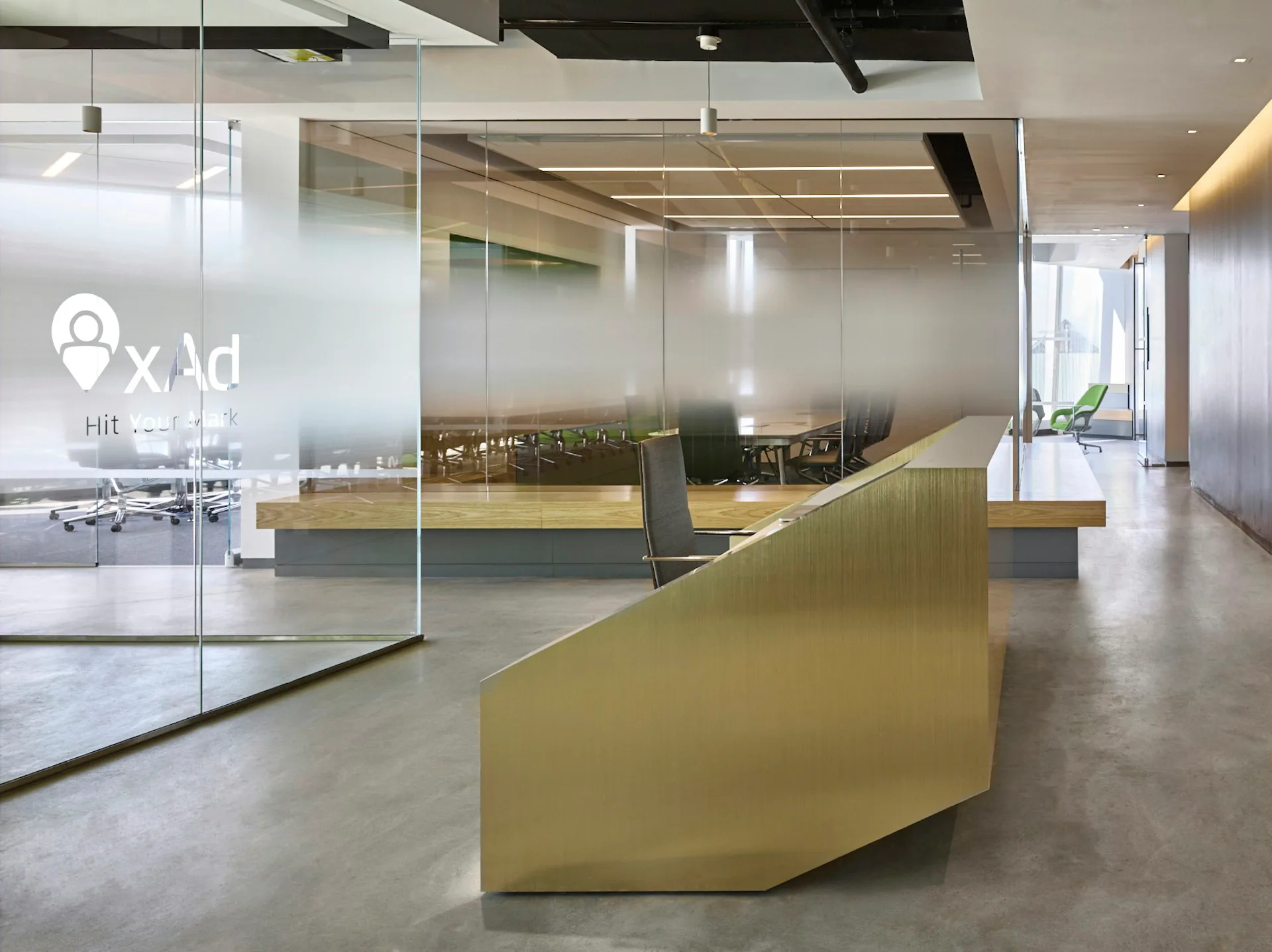 Modern office interior with curved yellow-green reception desk, glass partitions, polished concrete floors, and minimalist furnishings by Design Republic.