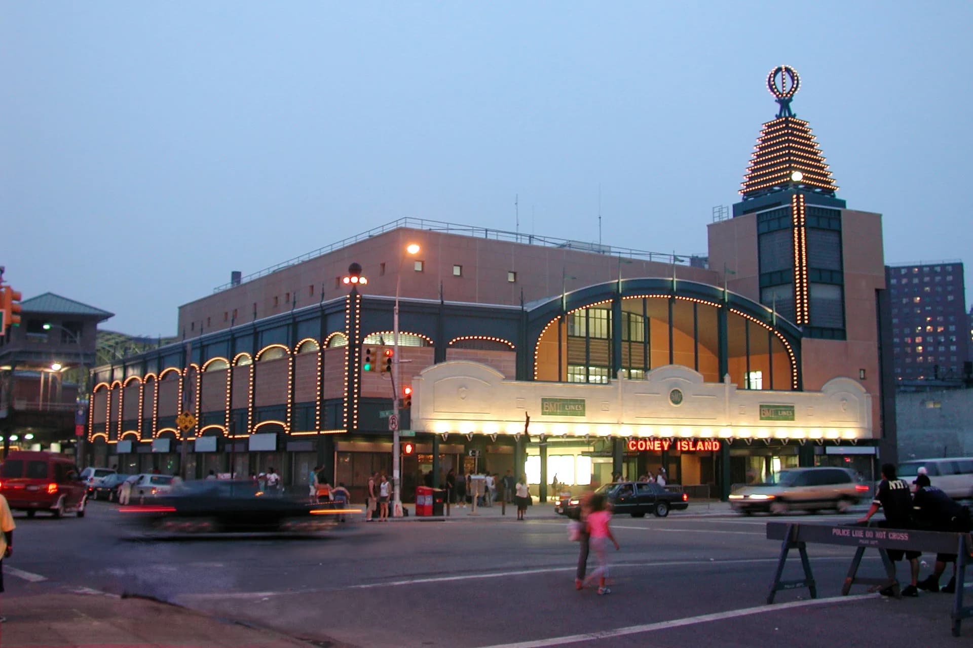 Lincoln Center plaza at dusk featuring illuminated historic architecture with warm golden lighting and ornate detailing by di Domenico + Partners, LLP