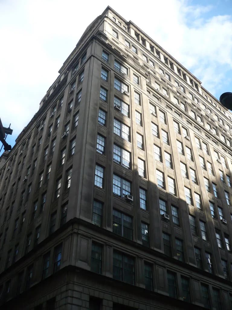 Exterior photograph of a multi-story classical masonry building with regular window fenestration and ornamental cornice detailing, designed by DJ Associates Architect, pc.