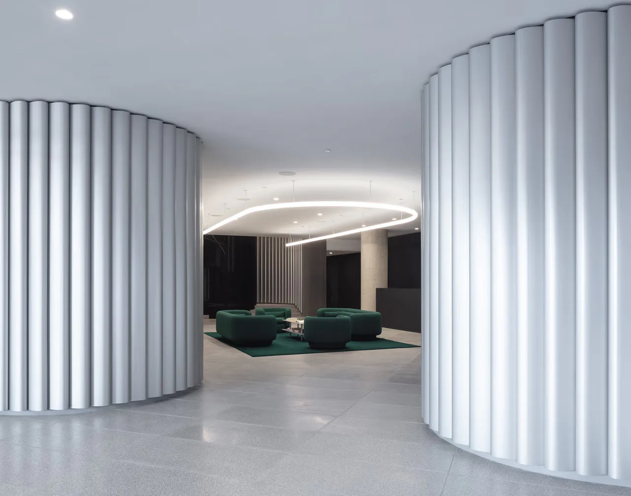 Modern interior with curved white vertical-slat partitions framing a seating area with green furniture and curved ceiling lighting by Dot Dash.