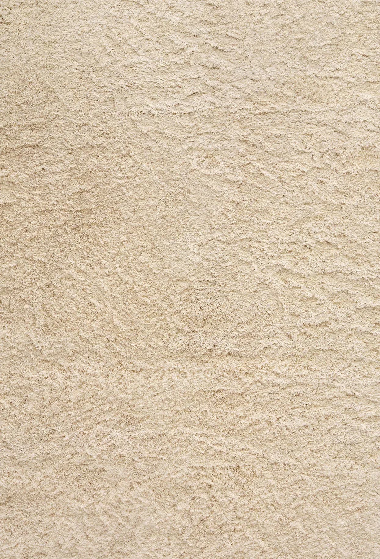 Textured beige plaster wall surface with subtle variations and natural finish detail by Ernesta.