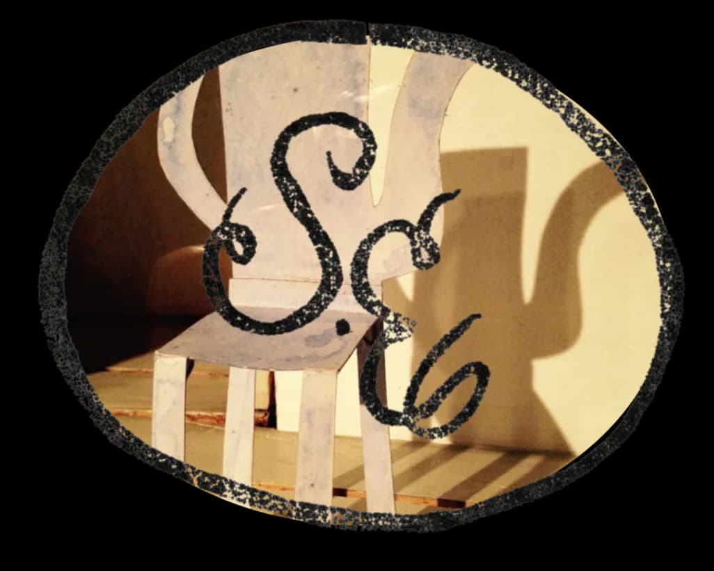 Ornamental wrought-iron mirror with scrolled details reflects a warm, cream-toned interior space with wooden architectural elements by Someplace Else.