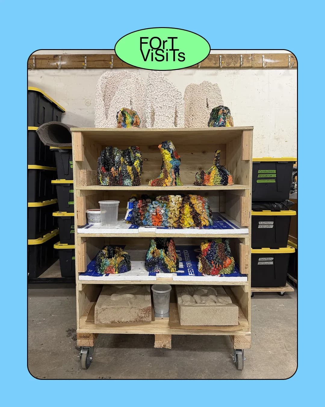 Wooden shelving unit displaying colorful crocheted cactus sculptures and desert-inspired installations by Fort Makers.