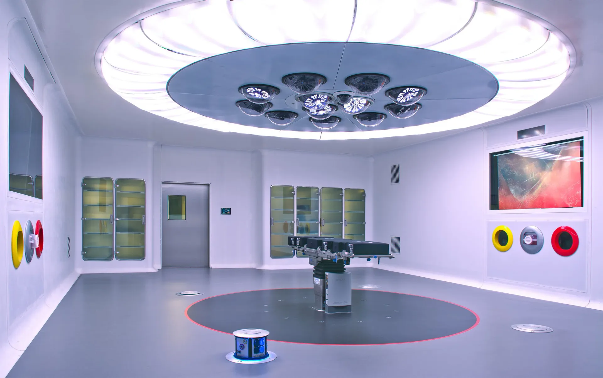 Modern circular interior space with purple ambient lighting, central circular platform, and integrated ceiling fixtures designed by Freyer Collaborative Architects.