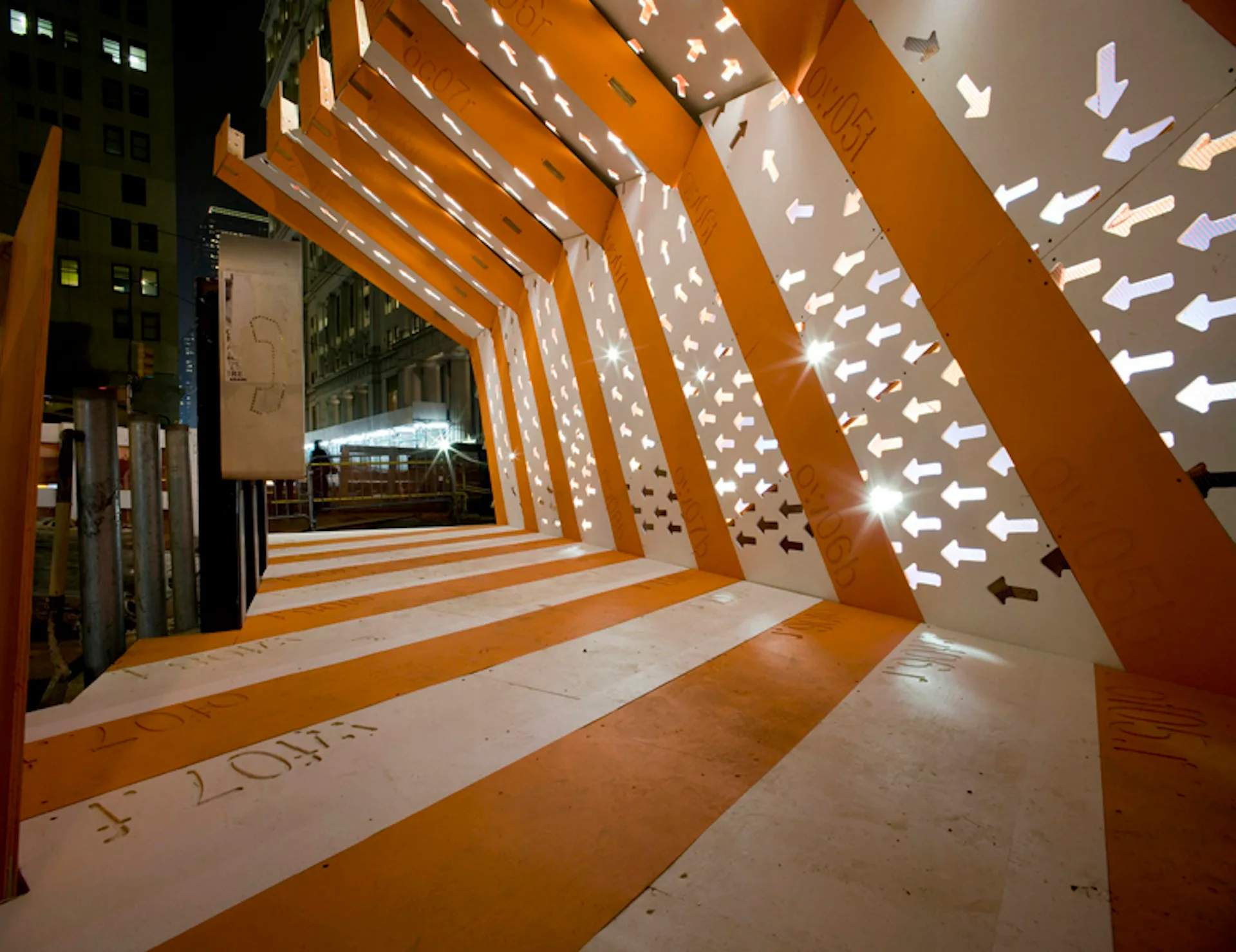 Orange wooden structural beams create geometric nested frames in a modern interior installation with patterned light projection on walls and floor by GRO Architects.