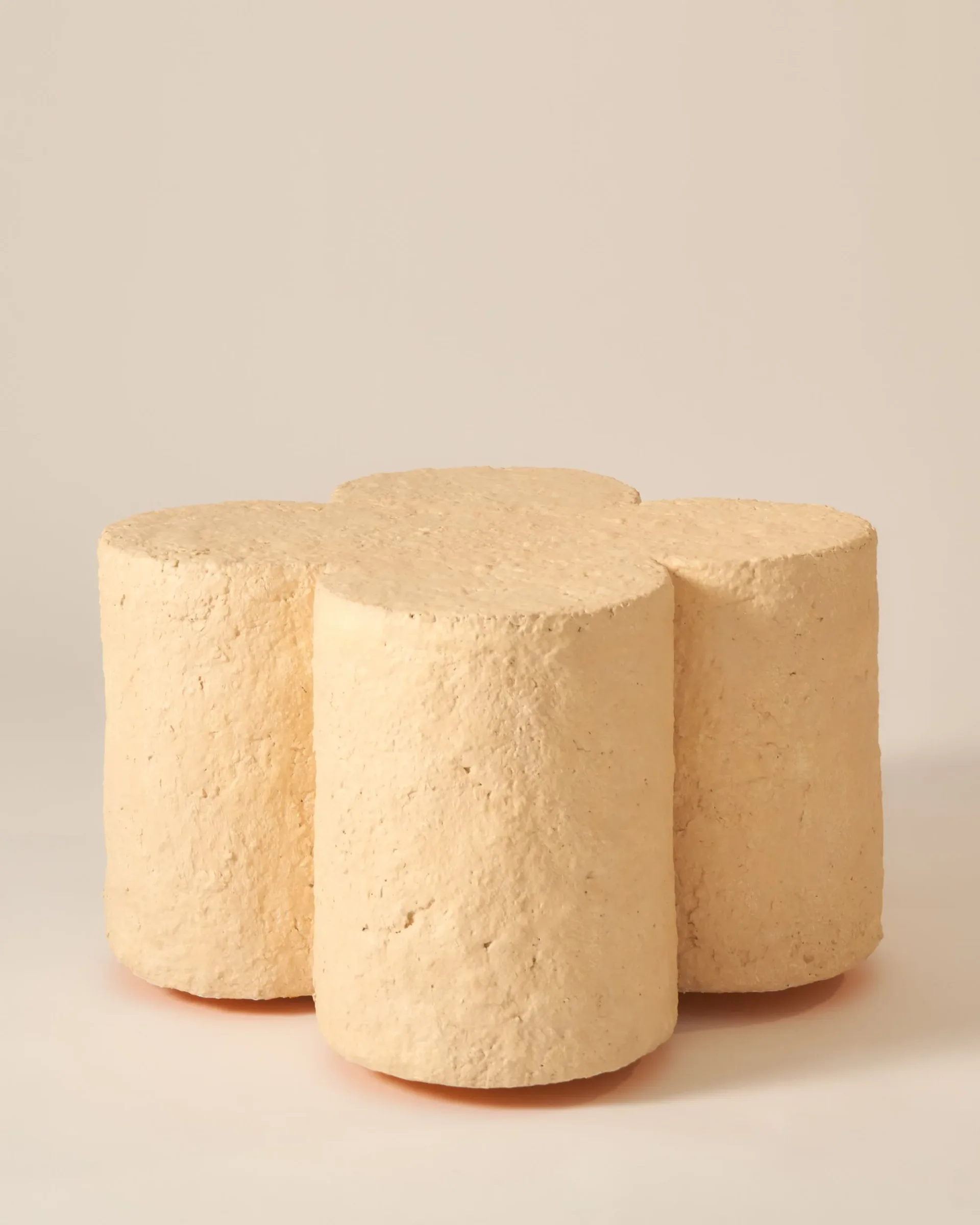 Three cream-colored cylindrical cork or cork-like objects arranged in a cluster against a neutral background, showcasing minimalist product design by H. Bigeleisen Studio.